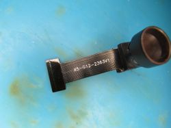 Black camera with X5-G12-2363V1 marking on a blue background