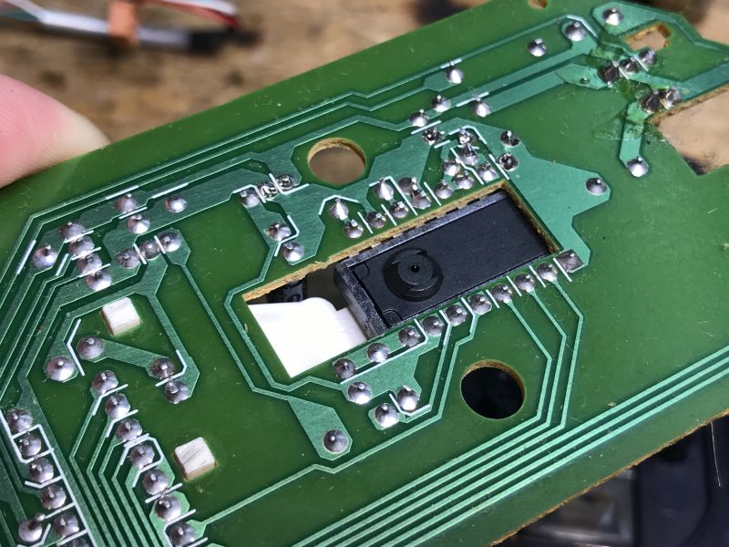 Interior of a Printed Circuit Board in an Old Mouse Close-up of a printed circuit board inside an old computer mouse.