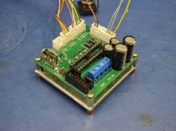 Soldered PCB with components and connector wires Soldered green PCB with connected wires and mounted capacitors.