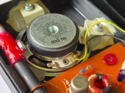 Close-up of AM radio interior with 50 Ω speaker and electronic components.