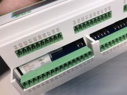 Close-up of terminal blocks with numbering and connectors of an automation electrical device.