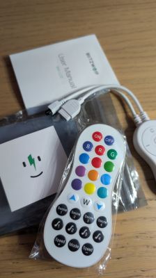 LED remote, BlitzWolf BW-CLT2 manual, and connectors on wooden table