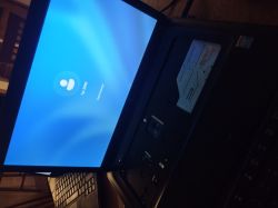 Laptop z włączonym ekranem logowania i odsłoniętą zatoką napędu optycznego