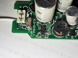 Close-up of a circuit board with visible capacitors and other electronic components.