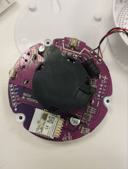Purple circular circuit board with mounted electronic components.