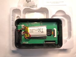 Interior of electronic device with visible 3.7V lithium battery and green PCB