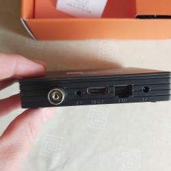 Rear panel view of the Mascom MC A102T/C TV tuner featuring AV, HDMI, LAN, and power ports.