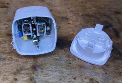 Open Electrical Socket Showing Internal Components Open plastic electrical socket with visible interior components.