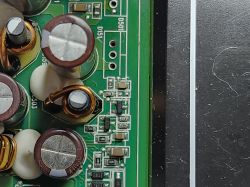 Close-up of circuit board with electronic components Section of green printed circuit board with capacitors and SMD components