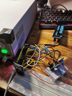 Complex electronic setup with wires connecting various modules on a desk.