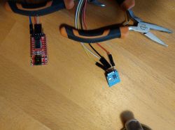 Roller Shutter Controller with Wires and Tools Roller shutter controller with connected wires and tools on a table.