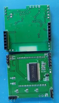 Two green PCBs with electronic components.