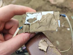 Flooded Electronic Relay Flooded electronic relay with a layer of dry sand.