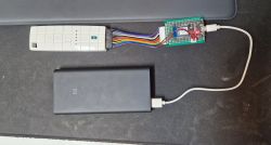Roller Blind Remote Connected to WiFi Module Roller blind remote connected to a WiFi module with wires and a power source.
