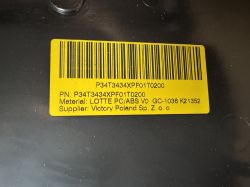 Label with Barcode and Serial Numbers on Philips OLED705 Casing Yellow label with barcode and serial numbers on a black TV casing.