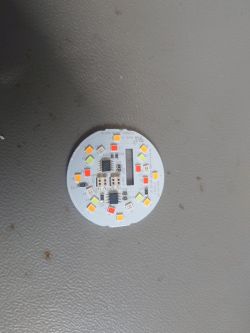 Circular electronic board module with LEDs and components.