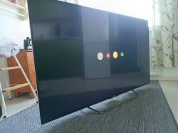 Sony TV on a carpet displaying the Android logo.