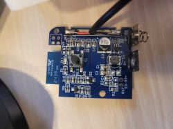 Blue PCB with electronic components including 470 inductor and capacitors