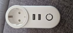 Electrical Outlet with USB Ports and Power Button White electrical outlet with two USB ports and a power button.