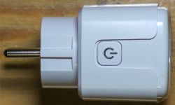 Tuya smart plug with a power button on the side.