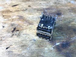 Dual USB connector on a wooden background.