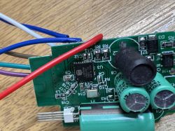 Close-up of a PCB with capacitors, wires, and an integrated circuit