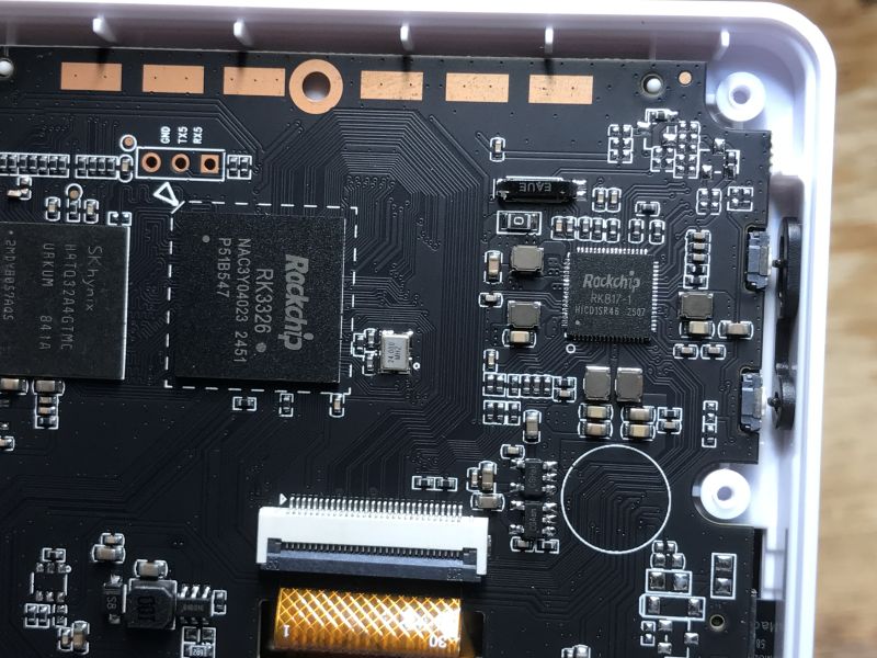 Close-up of PCB with Rockchip RK3326 and RK817 chips in a handheld game console