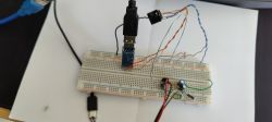 Breadboard with various connections and wires connected to USB ports.