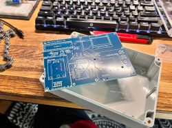GPS Project PCB Board in Prototype Casing PCB board with a GPS project placed in a casing on a desk.