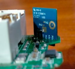 Close-up of a circuit board with a mounted CB2S module marked with RX2, TX2, and a serial number.