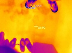 Thermal image of floor with temperature labels and outline of footwear