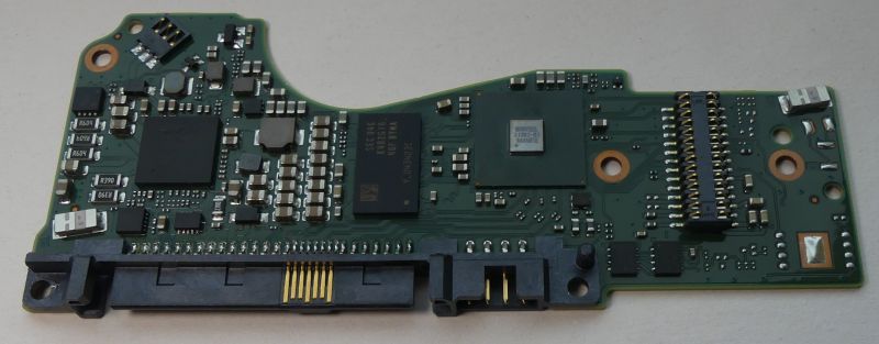 PCB from a SATA hard drive featuring various integrated circuits and connectors.