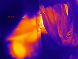 Thermal image of a portable air conditioner and exhaust hose with temperature readings.