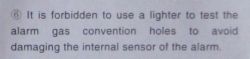 Image of a section of instructions forbidding the use of a lighter to test the gas alarm's ventilation holes to avoid damaging the internal sensor of the alarm.