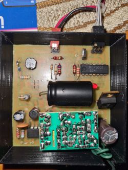 Interior of Device with Printed Circuit Board and Electronic Components View of the interior of an electronic device with a mounted printed circuit board featuring various components.