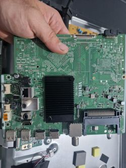 Mainboard VESTEL 17MB170E from a TV held in a hand