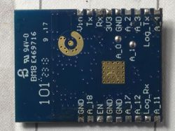 Electronic module with pin labels on a blue board.