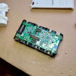 Dreame V9 Battery and Circuit Board Battery and circuit board from Dreame V9 vacuum cleaner laid out on cardboard.