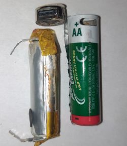Interior of a Damaged AA Battery Disassembled AA battery with visible damage and corrosion.