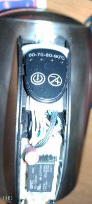 Close-up of the interior of a Hoffek AK3502 electric kettle showing the button and wires.