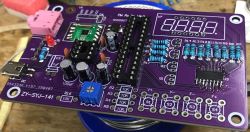 Purple FM radio PCB with soldered components and footprint for a 4-digit 7-segment display