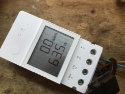 White Sonoff energy meter on a wooden background