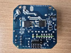 Printed circuit board with various components on a wooden surface.