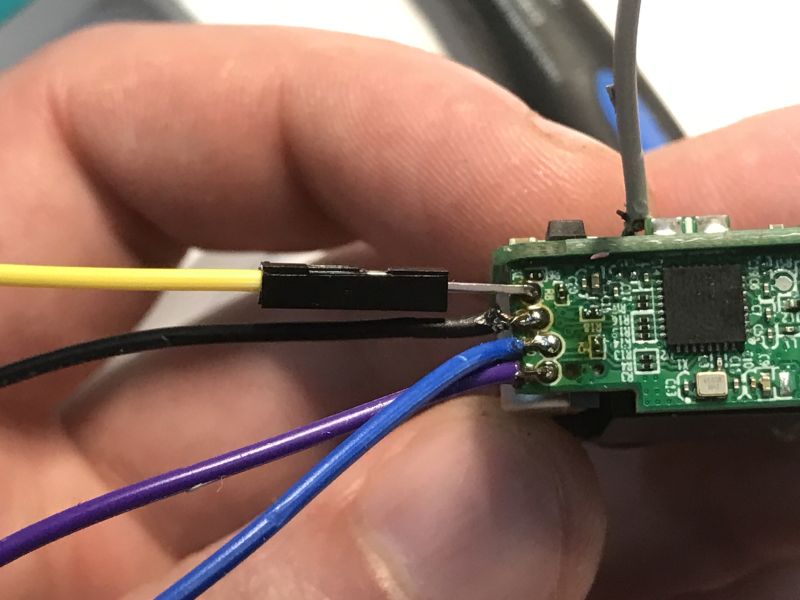 Close-up of Sonoff MINIR4M PCB with wires connected to RX, TX and GND pins