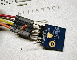 CB2S module with attached wires and a resistor on an EliteBook laptop.