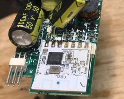 Close-up of a PCB with CB2L Wi‑Fi module and a large 100 µF 50 V electrolytic capacitor