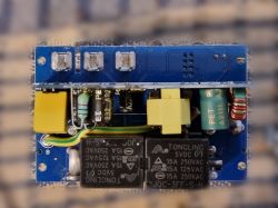 Relay module on a printed circuit board Circuit board with relay, capacitors, and screw terminals
