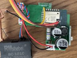 Electronic module with components, capacitors, wires, and a relay.