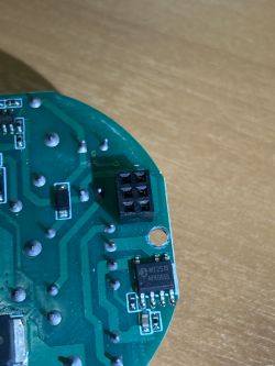 Close-up of a printed circuit board with visible traces, mounting holes, and electronic components.