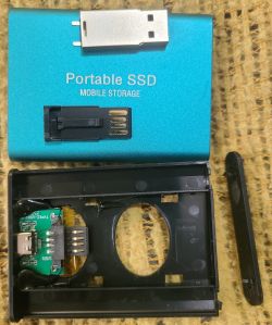 Disassembled Portable SSD Enclosure Disassembled portable SSD enclosure with visible USB port and internal circuit board.